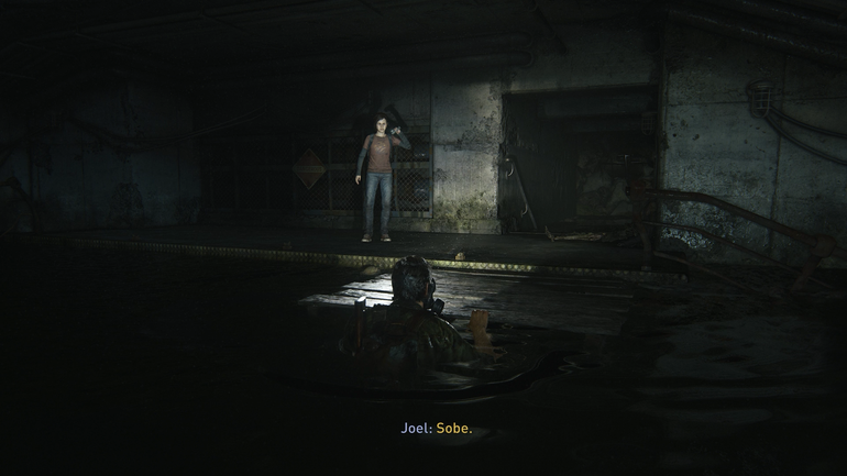 Joel e Ellie num cenário escuro.